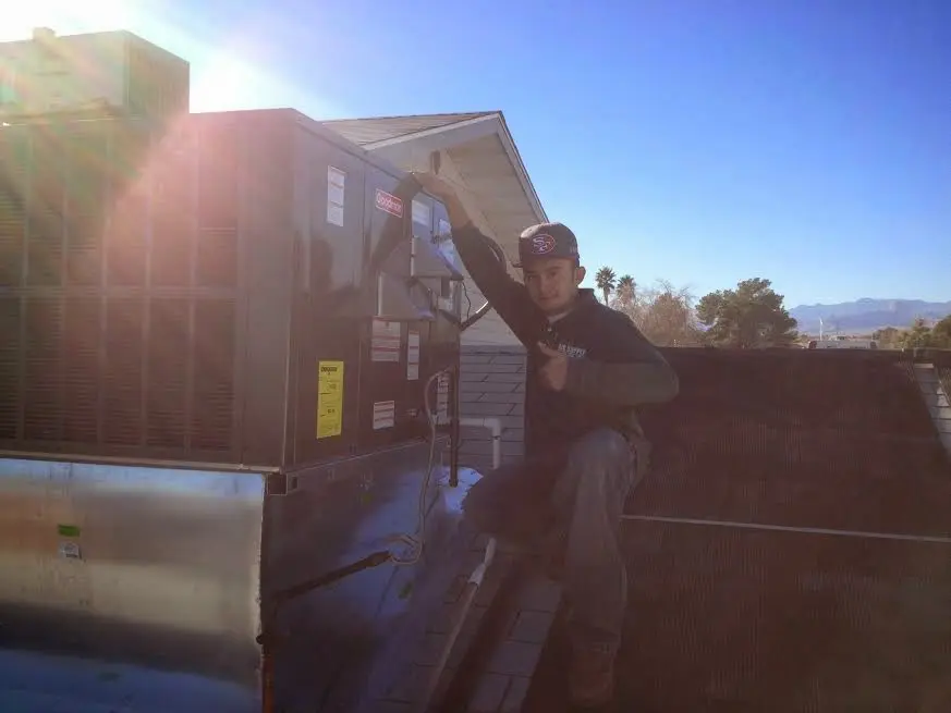 HVAC technician performing HVAC Inspection on a rooftop unit in Waxahachie